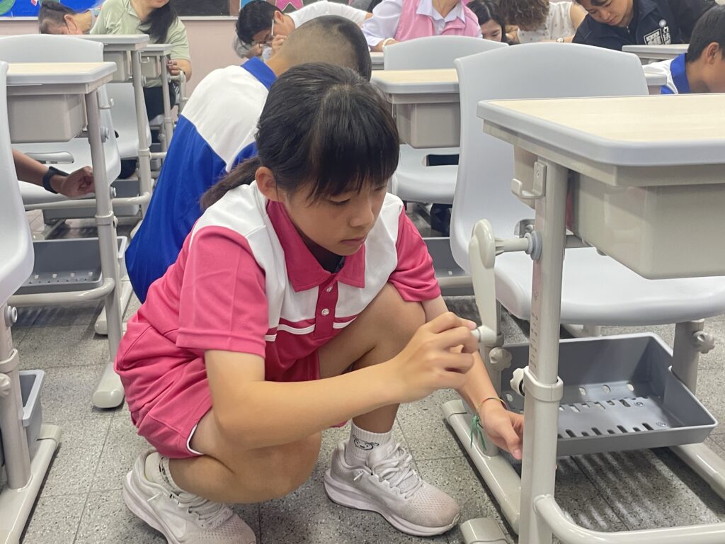 中市校園設備大升級 全面採用可調式課桌椅 1 02 學生示範如何利用搖桿進行課桌椅調整